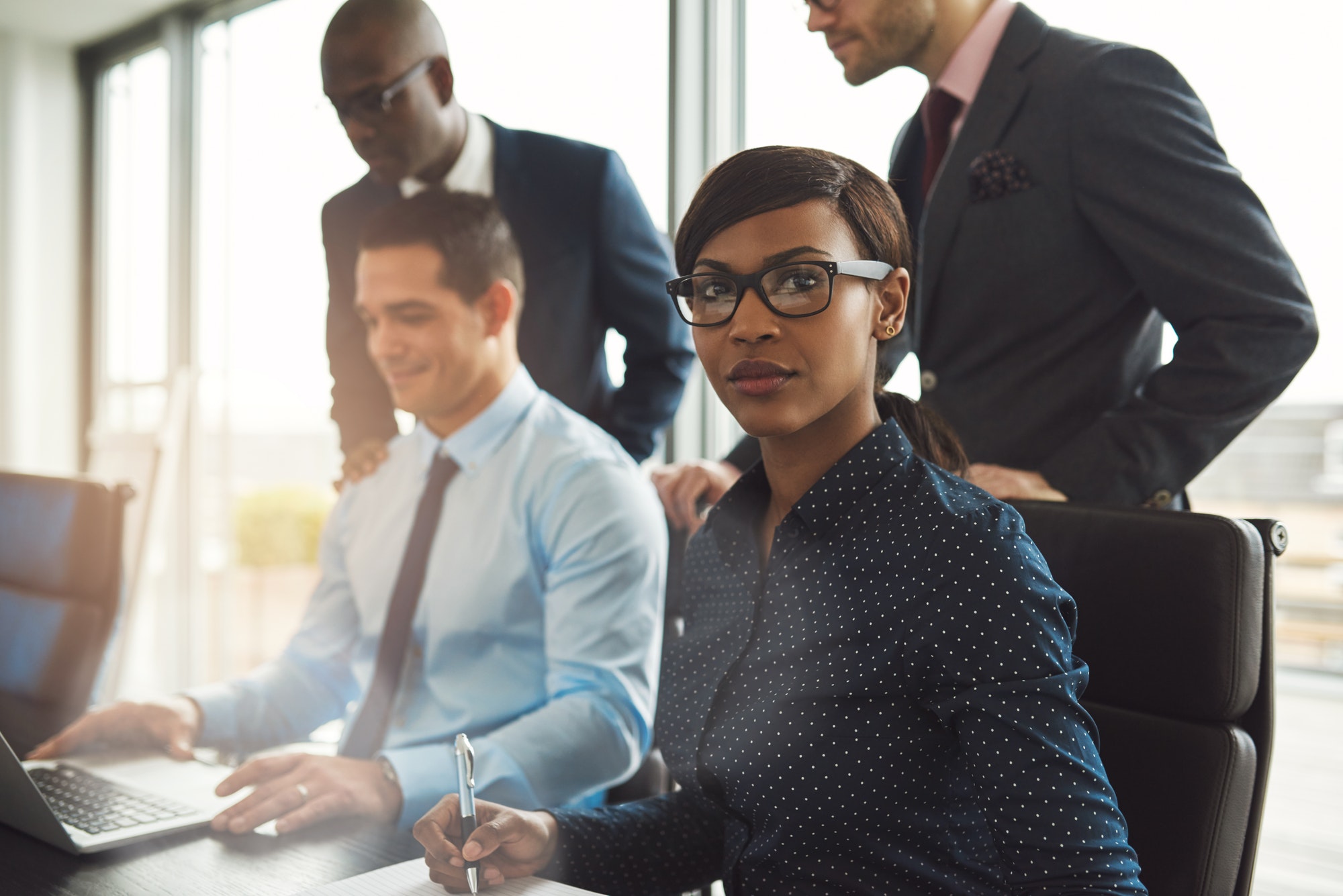 Businesswoman with male co-workers in office